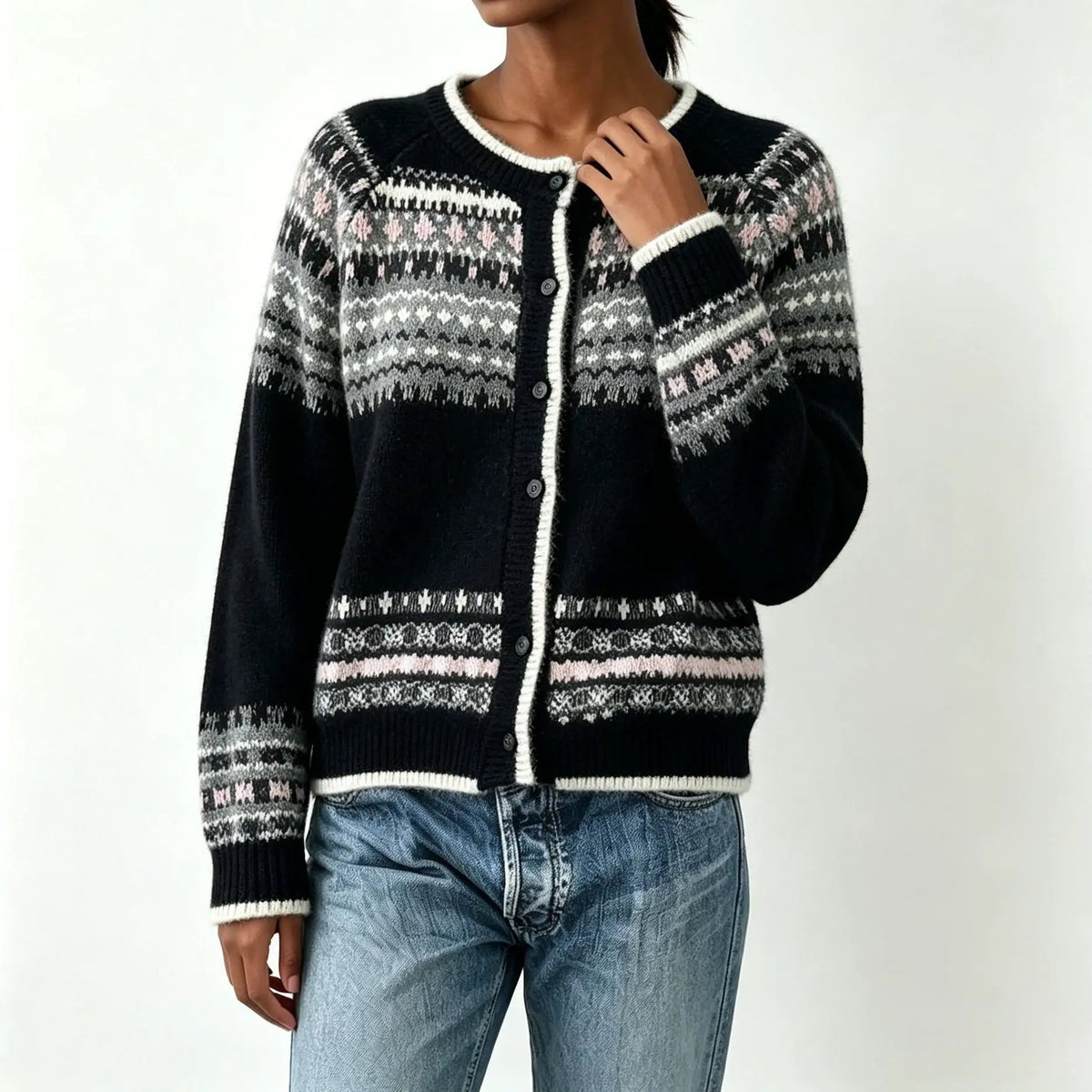 Color-block knit cardigan with black, gray, white pattern and white trim, round-neck, button front.