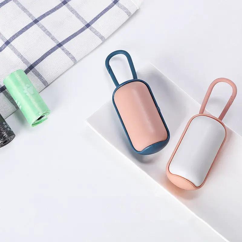 Portable poop bag holder for cats and dogs; blue-trim pink body and peach-trim gray body, two units.