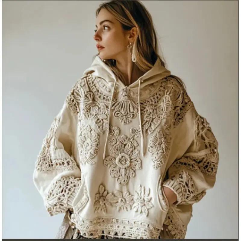 Hooded women's beige hoodie with intricate floral embroidery and oversized fit.