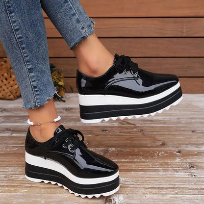 Women's lace-up square-toe patent leather platform wedge heels, black with a chunky white and black sole, pair shown.