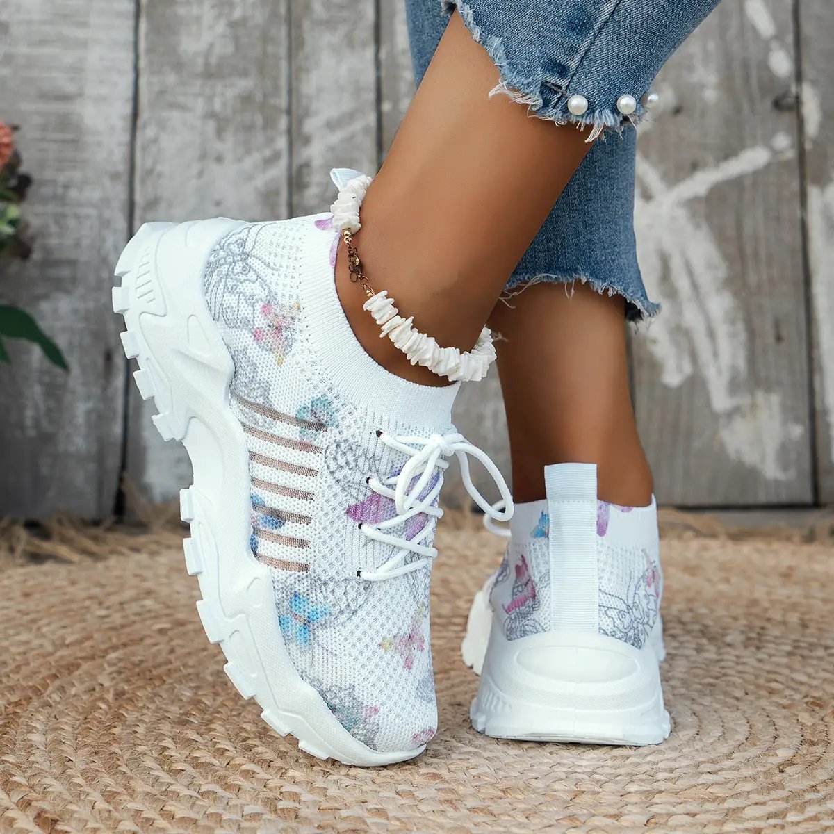 Women's white butterfly-print mesh sneakers with a chunky sole and lace-up closure