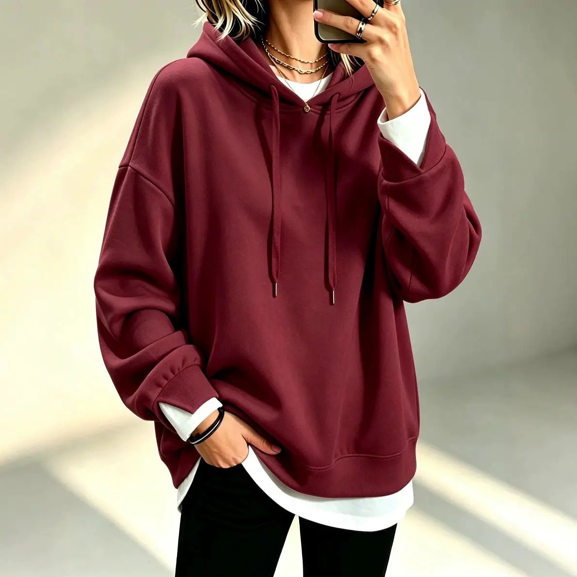Plus-size loose-fit long-sleeve solid-color hoodie in burgundy, layered over a white tee.