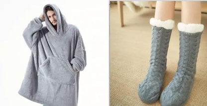 Two-item clothing set: gray oversized hoodie blanket with pocket and gray knit socks with white faux fur cuffs