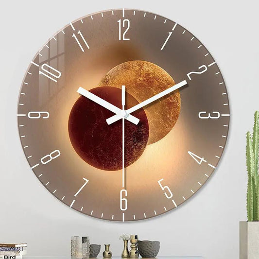 Wall-mounted decorative clock with overlapping gold and burgundy spheres, white hands