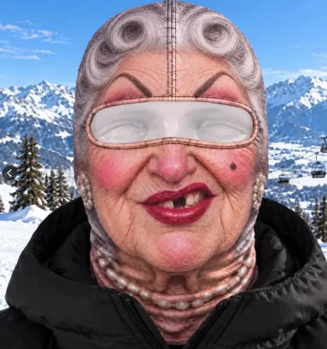 Realistic beige AdTec balaclava ski mask with eye window worn by woman in snowy mountains.