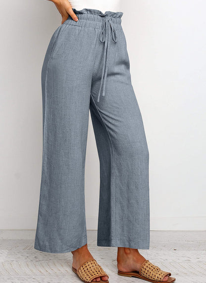 Pantalon large à taille élastique, lacets et coupe courte de couleur unie