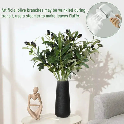 Artificial olive branch with leaves and fruit in a black vase, home decor accessory