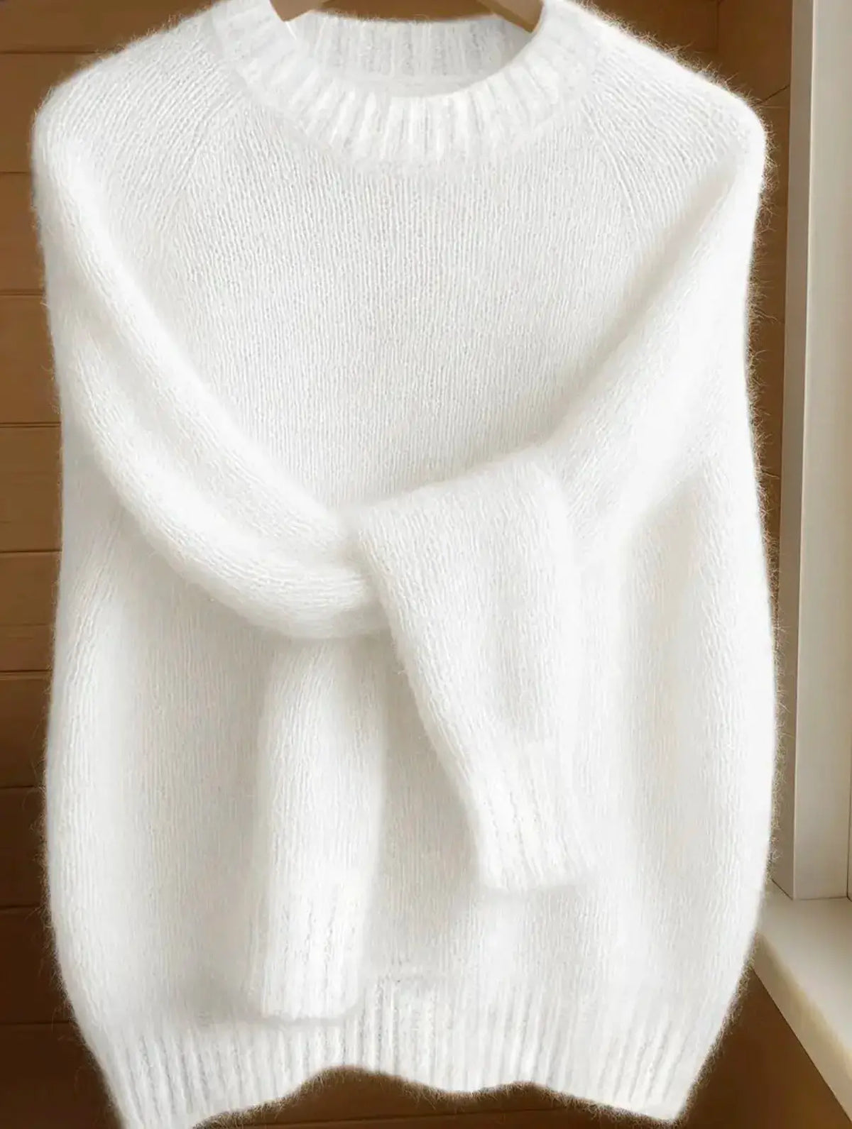 Womens soft cozy knit sweater in white fluffy yarn with ribbed crew neck and long sleeves.
