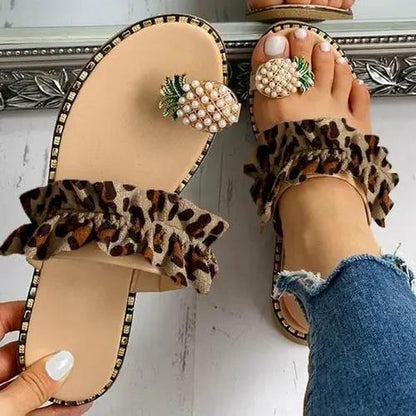Pineapple Pearl Beach Slides pair with leopard ruffle straps and pearl pineapple embellishments on tan soles