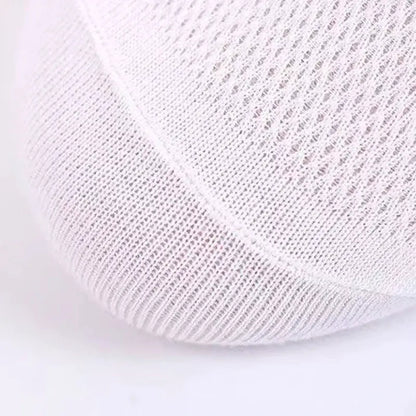 White cotton ankle socks close-up showing breathable knit fabric and sweat-absorbent comfort for everyday wear