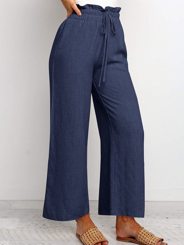 Pantalon large à taille élastique, lacets et coupe courte de couleur unie