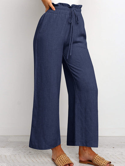 Pantalon large à taille élastique, lacets et coupe courte de couleur unie