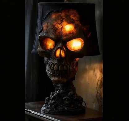 Halloween lava stone skull desk lamp with glowing orange LED eyes on a mantel.