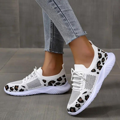 Pair of white leopard-print lace-up sneakers for women with knit mesh upper.