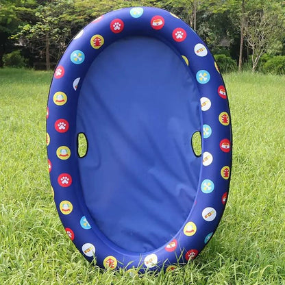 Dog pool inflatable hammock float, blue ring with colorful circular decals, on grass.