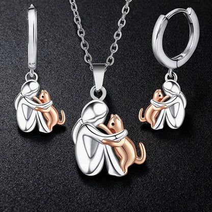 Ensemble de boucles d'oreilles Fillette et Chien s'enlaçant