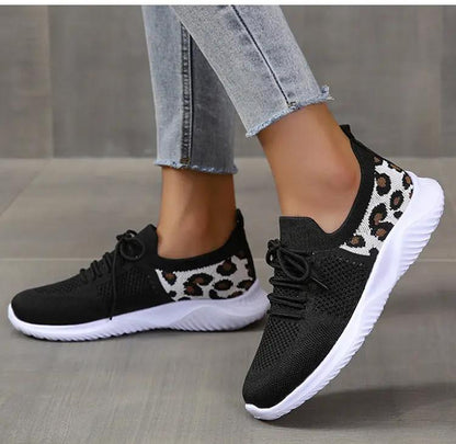 Leopard-print lace-up sneakers by AdTec; black knit upper, white sole, pair.