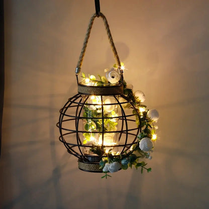 Battery-powered hanging lantern with a dark metal hemp-rope cage and warm fairy lights, 7.3 inches tall