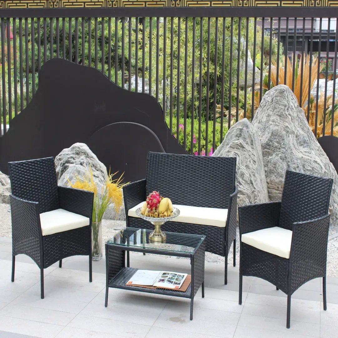AdTec 4-piece black rattan patio set with beige cushions; includes two armchairs, a loveseat, and a glass coffee table.
