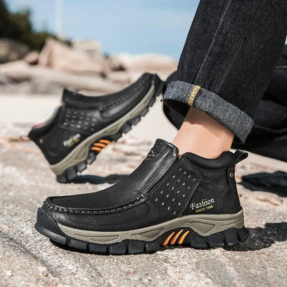 Mens casual metal ankle boots black leather with a rugged gray sole and orange accents.