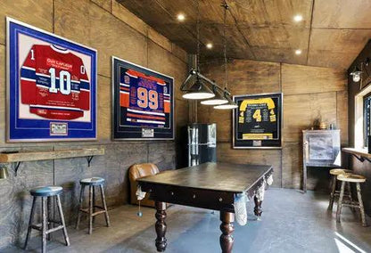 Paul Coffey Career Jersey framed and autographed LTD ED 199 on wall display in rustic game room with pool table