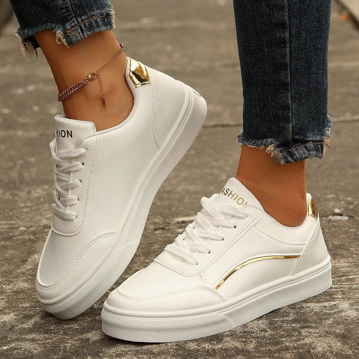 White lace-up flats sneakers for women with a thick sole and gold heel detail