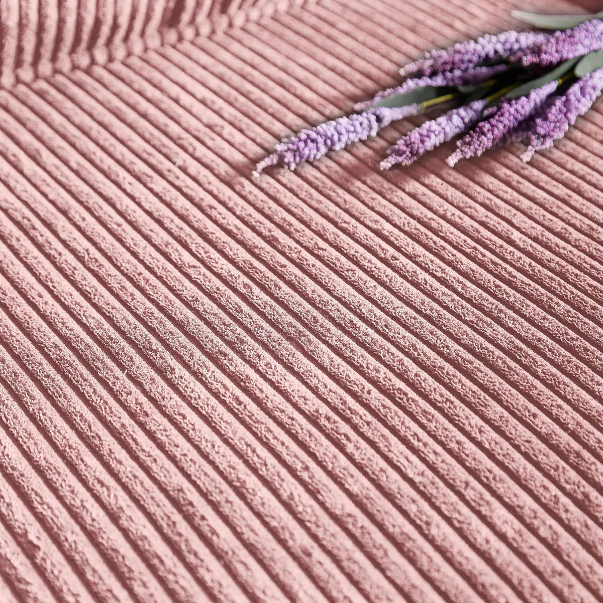 Corduroy sofa upholstery in pink with ribbed texture