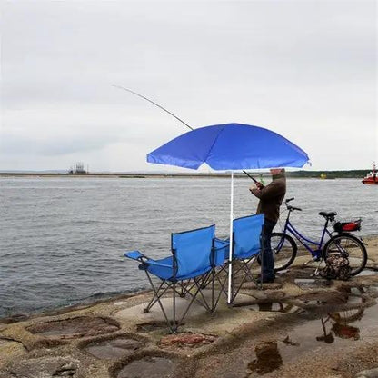 Portable outdoor 2-seat folding chair with removable sun umbrella, two blue chairs by water with a person fishing.