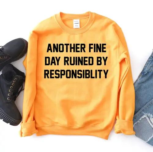Another Fine Day Sweatshirt, orange with bold black front text; shoes and denim jeans visible.
