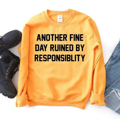 Another Fine Day Sweatshirt, orange with bold black front text; shoes and denim jeans visible.