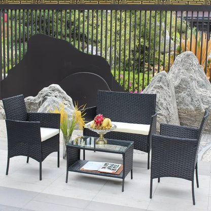 4-piece black wicker rattan patio furniture set with glass-top coffee table and beige cushions