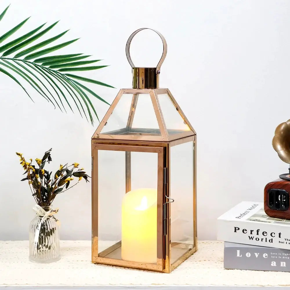 16 inch high decorative lantern by JHY DESIGN with brass finish, glass panels, and candle inside