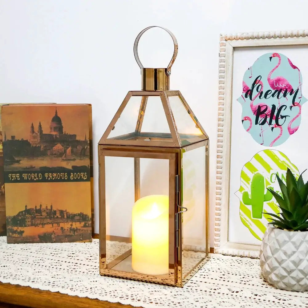 16-inch high decorative lantern with gold metal frame, glass panels, candle inside