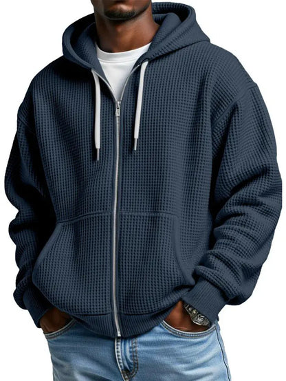 Men's navy zip-up hoodie with waffle-knit fabric, kangaroo pockets and ribbed cuffs