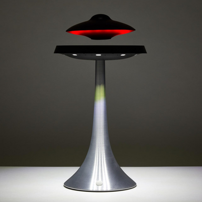 Levitating UFO Speaker by PrimeCanada.Store, silver pedestal with black disc and red glow